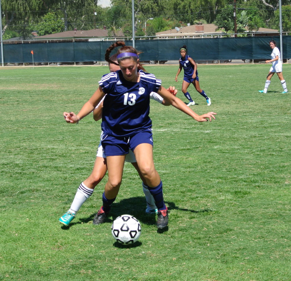 Freshman forward Amber Grosso fights off a tackle from a Jaguar defender, in the Hornets 2-1 loss on Tuesday.