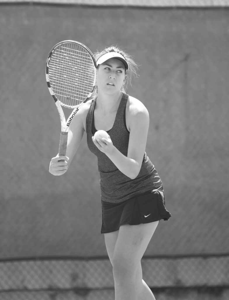 Captatin Cailin Mitchell gets ready to unleash a serve as the Hornets’ women’s tennis team prepares for the State Championship Tournament. Photo credit: Mathew Flores