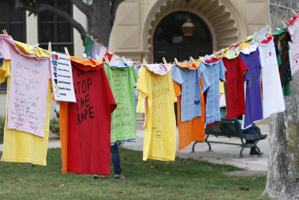 More than a hundred shirts were displayed on the Quad, each with a testimonial from someone who survived some form of abuse; each kind represented by a different color shirt. Photo credit: Mathew Flores