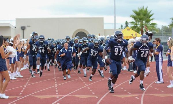 The Hornets storm onto the field before their matchup against Golden West on Saturday night. FC defeated GW 66-43