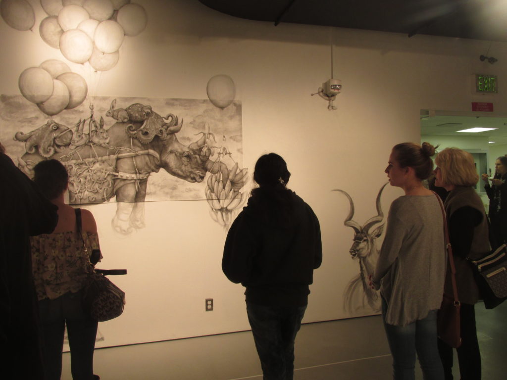 Rhinos and bananas by Adonna Khare with additional pencil drawings added on directly to the gallery wall. Photo credit: Gina Allstun