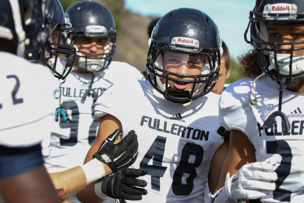 Fullerton defensive back Josh Nelson #48 celebrates with teammates after his interception returned for a touchdown against Grossmont College Saturday at Mashin-Roth Stadium. Photo credit: Chelena Gadson