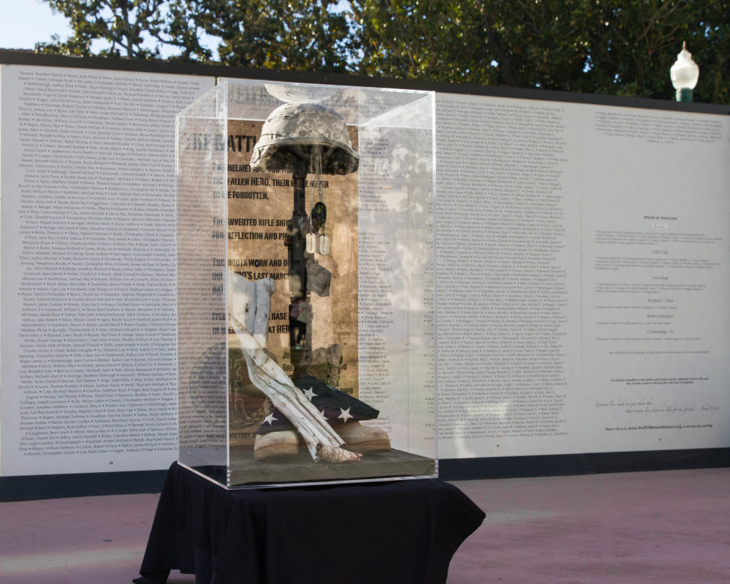 A battle cross sits in front of the Global War on Terror Wall of Remembrance. Photo credit: Patrick Quirk