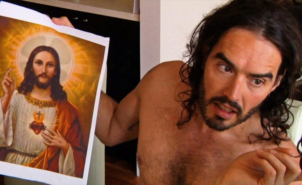Russel Brand holds up a picture of Jesus Christ Photo credit: IMDB
