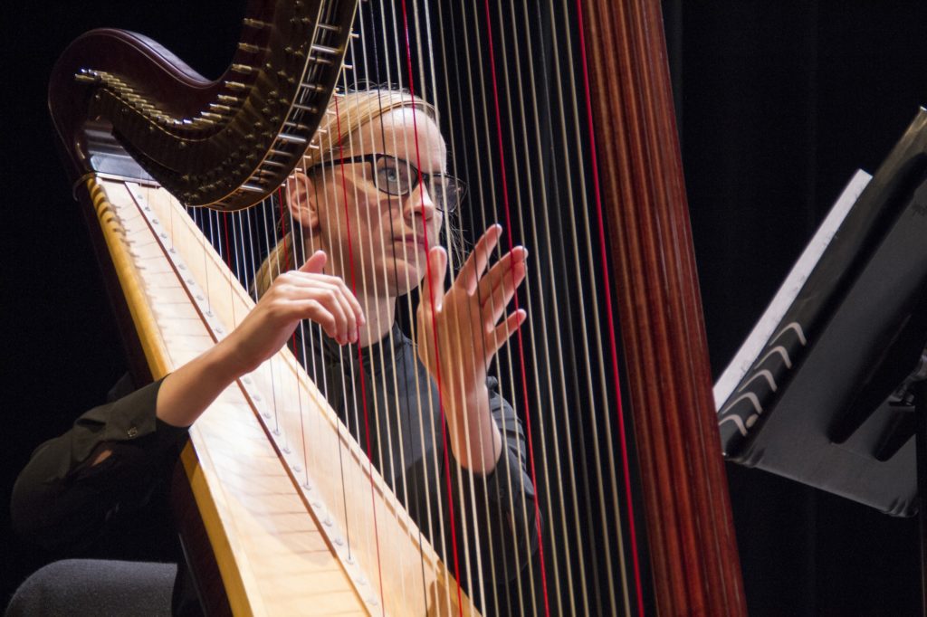 Harpist performing a number with the FC Symphony at the FC Campus Theatre Monday, November 23 during the Winter Showcase. Photo credit: Marissa Gonzalez
