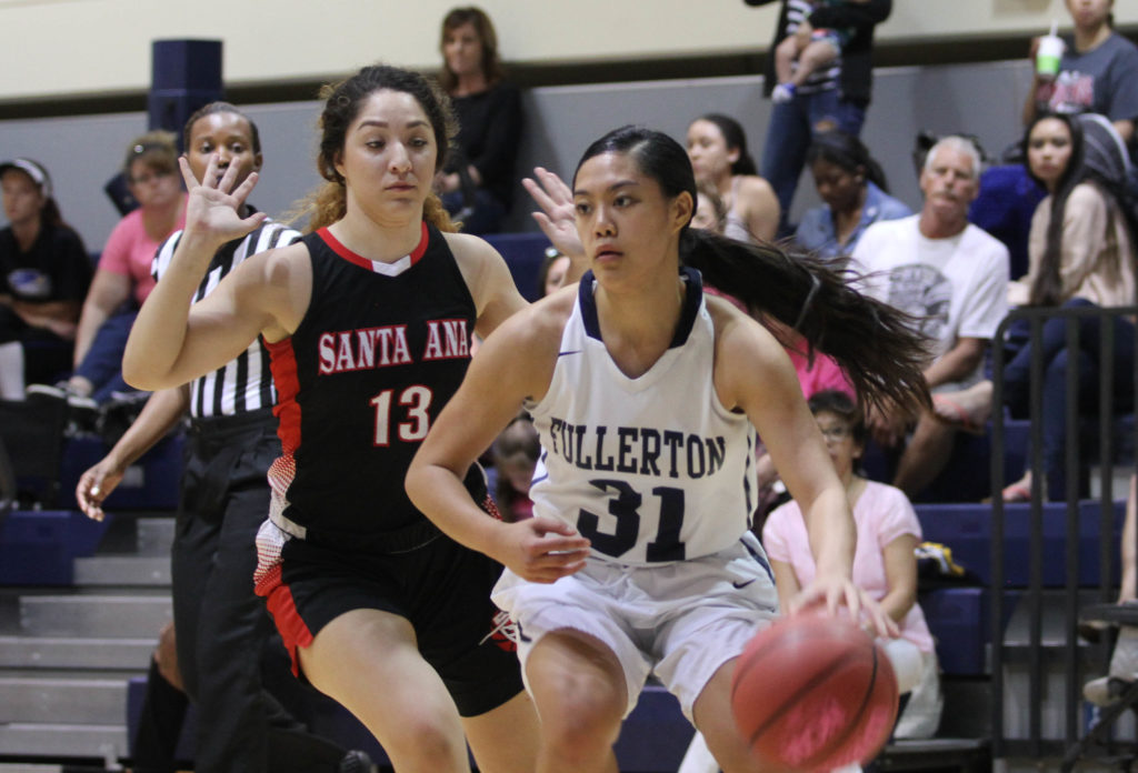 Hornet sophomore guard Emilee Dy No. 31 drives to the basket against Santa Ana at Fullerton College, Feb 11. Photo credit: Chelena Gadson