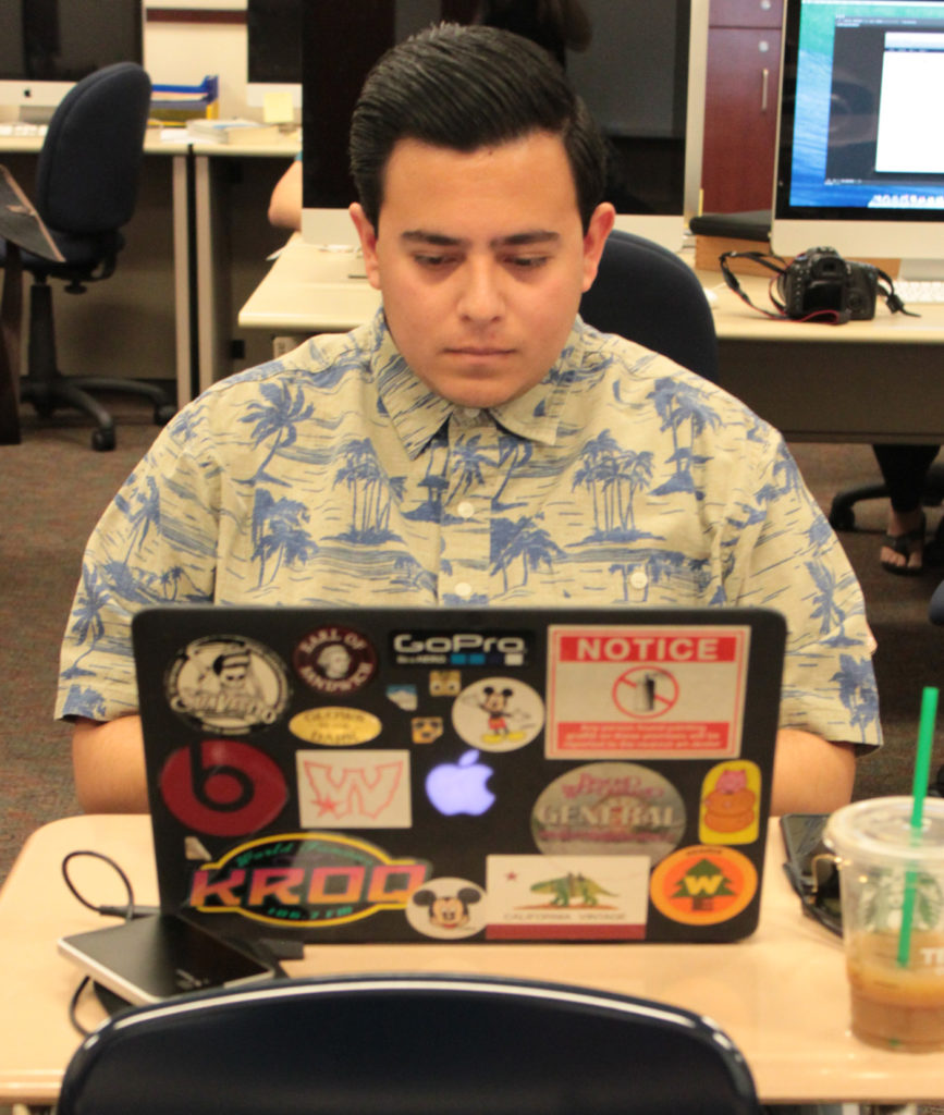 Mathew Flores saves space on his desk by reading an ebook. Photo credit: Priscilla Aguilera