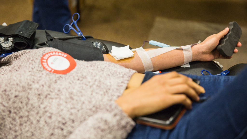 Monica Esteros, an undeclared mjor student, squeezes a foam block to get blood pumping during donation on Tuesday in the 200 building. Photo credit: Christian Fletcher