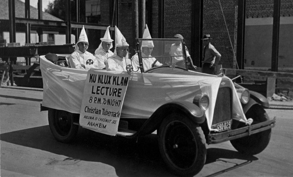 4 KKK members driving through the streets of Anaheim promoting  Klan meeting. Photo credit: The Anaheim Colony