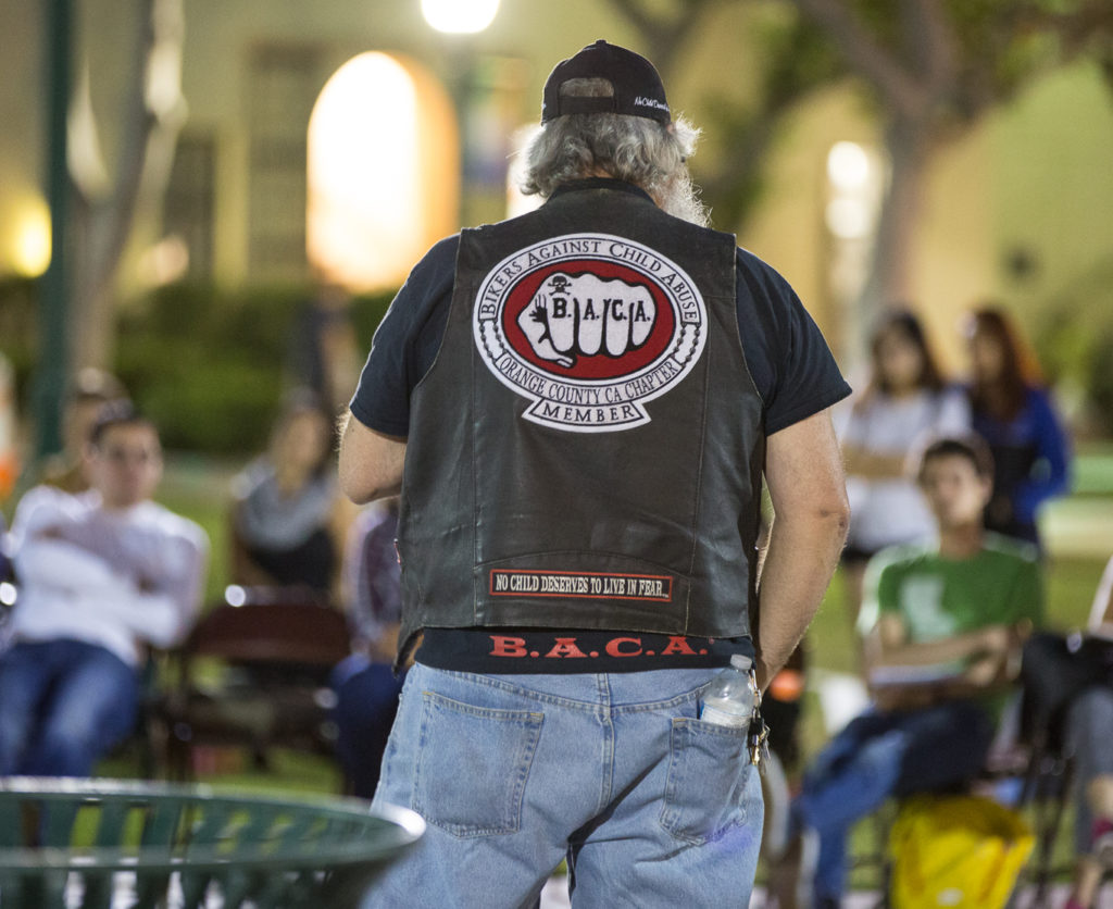 The leader of the Orange County Chapter for Bikers Against Child Abuse (B.A.C.A) who goes by Santa addressed the crowd about what his group does and requirements for joining at Take BAck the Night. Photo credit: Christian Fletcher