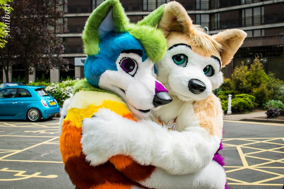 Image of two Furries hugging wearing higher-end fursuits. Photo credit: Facebook