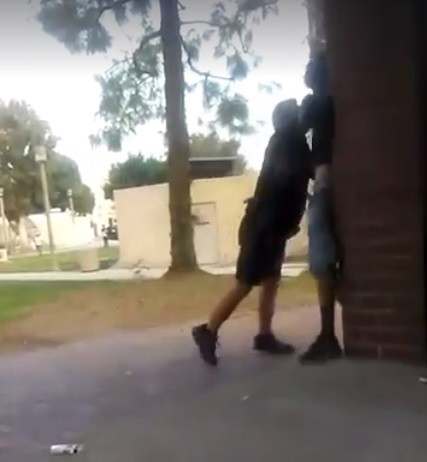 FC Campus Safety Officer slams the man against a brick wall before pulling him to the ground on video. Photo credit: OC Weekly