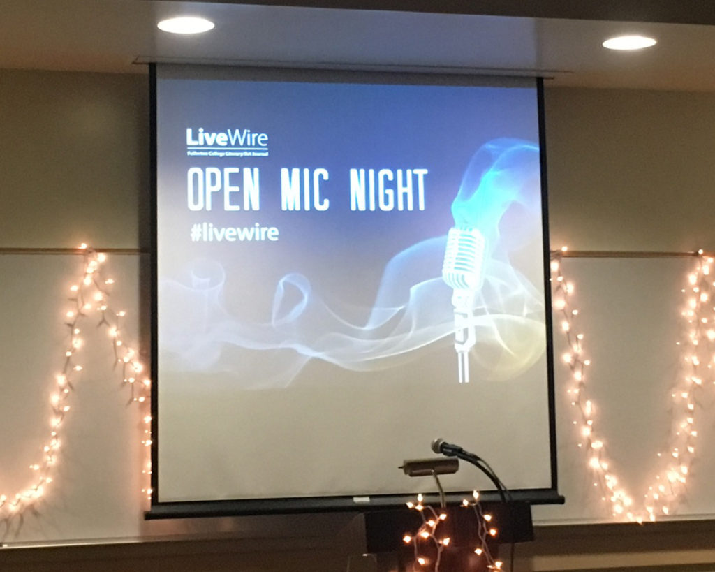 Lights strung behind the podium lit the stage beautifully for writers at the LiveWire Open Mic Night. Photo credit: Jeff Watson