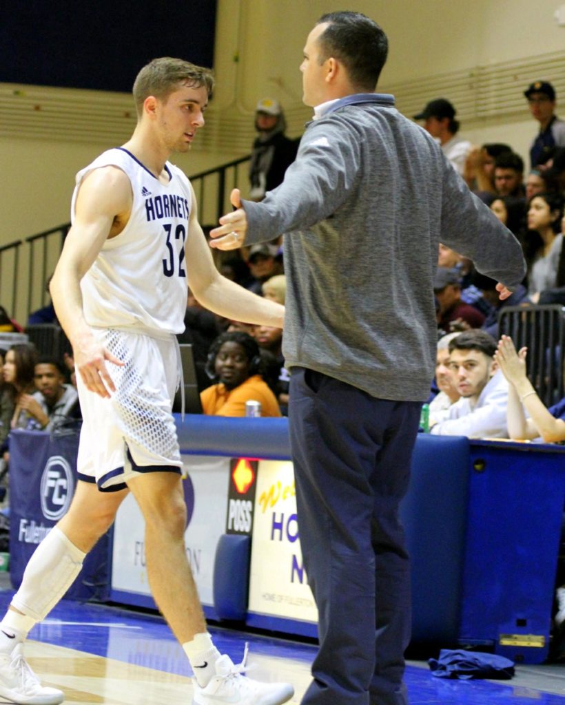 Head coach Perry Webster praising Ian Fox as he steps off the court during last weeks game. Photo credit: Noah Jimerson