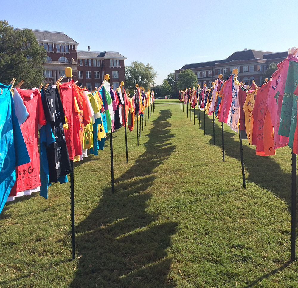 Vivid T-shirts put on display on a campus lawn at Mississippi State University. Photo credit: clotheslineproject.org