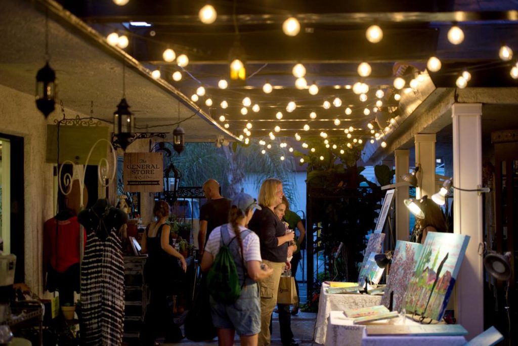 Success of the first friday artwalk in Fullerton has expanded to retail stores, restaurants and store fronts. The passageway by the General Store displays paintings, while the stores enjoy extra foot traffic inside. Photo credit: Matt Masin