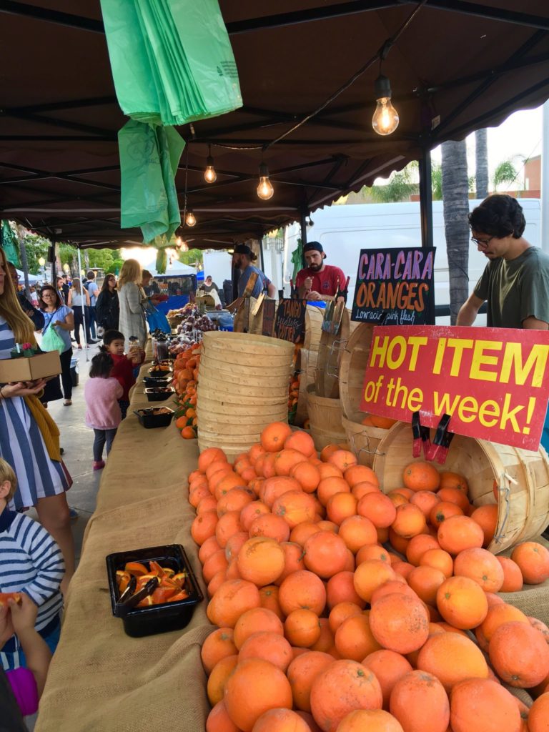 One of a few produce stands showcasing beautiful oranges and their hot item of the week. Photo credit: Katie Brown