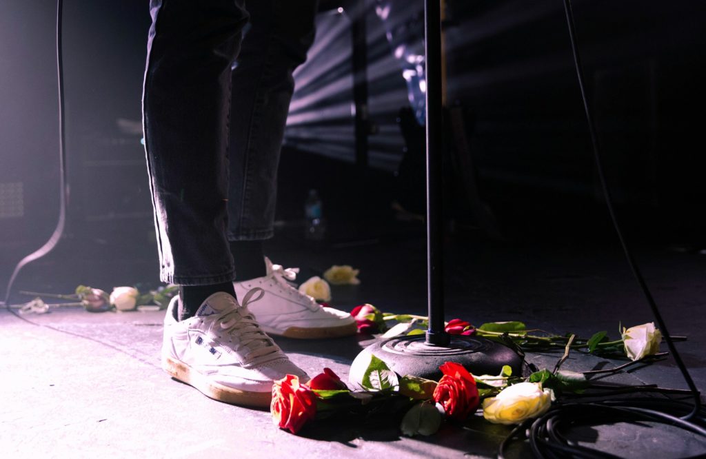 Fans throwing roses on stage in-theme with LANYs upcoming self-titled album, which is due to release June 30, during their set at The Glass House in Pomona.