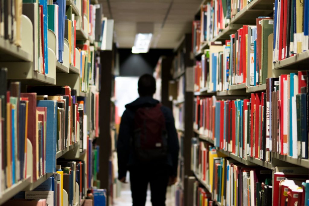 Student walking a library Photo credit: Pexels
