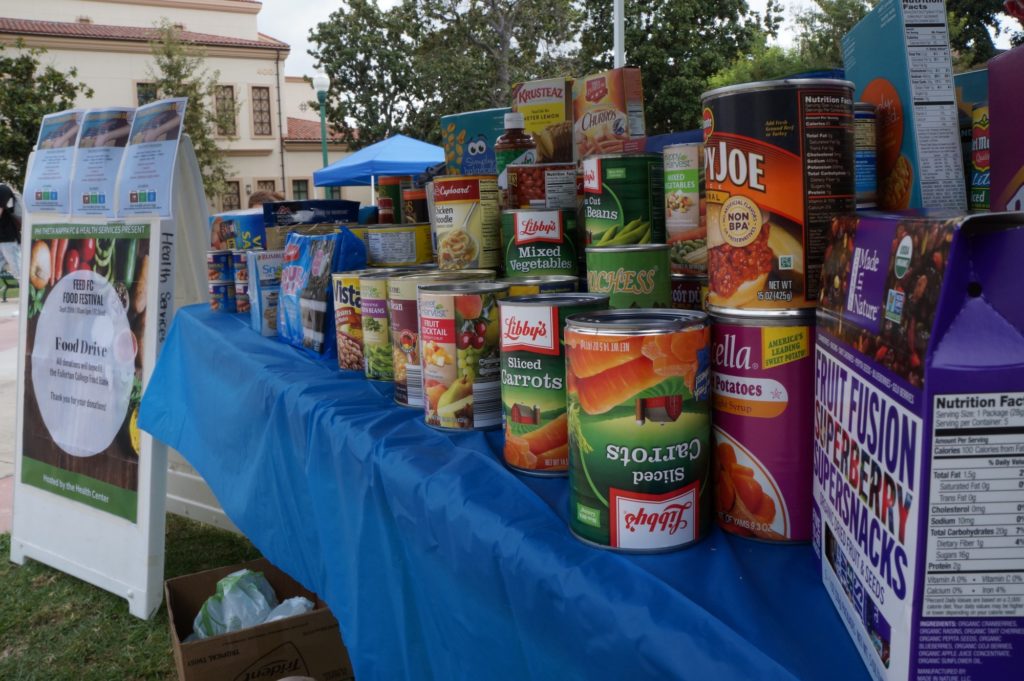 The Feed FC Food Festival displayed their recently donated food items during the event. The amount of items on the table grew as more people stopped by to donate. Photo credit: Aaron Untiveros