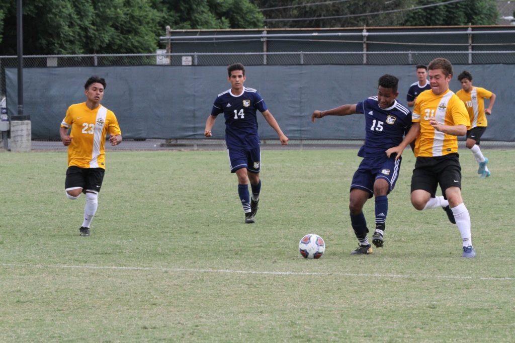 Midfielder Luis Dirico moves past the Rustlers during the conference game. Photo credit: Rebecca Radtke
