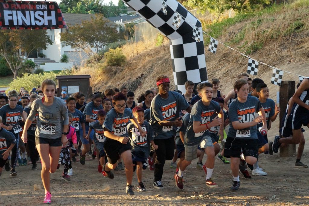 Children from varying school organizations, eager to start the race, hit the ground running to finish the 5k run. Photo credit: Aaron Untiveros