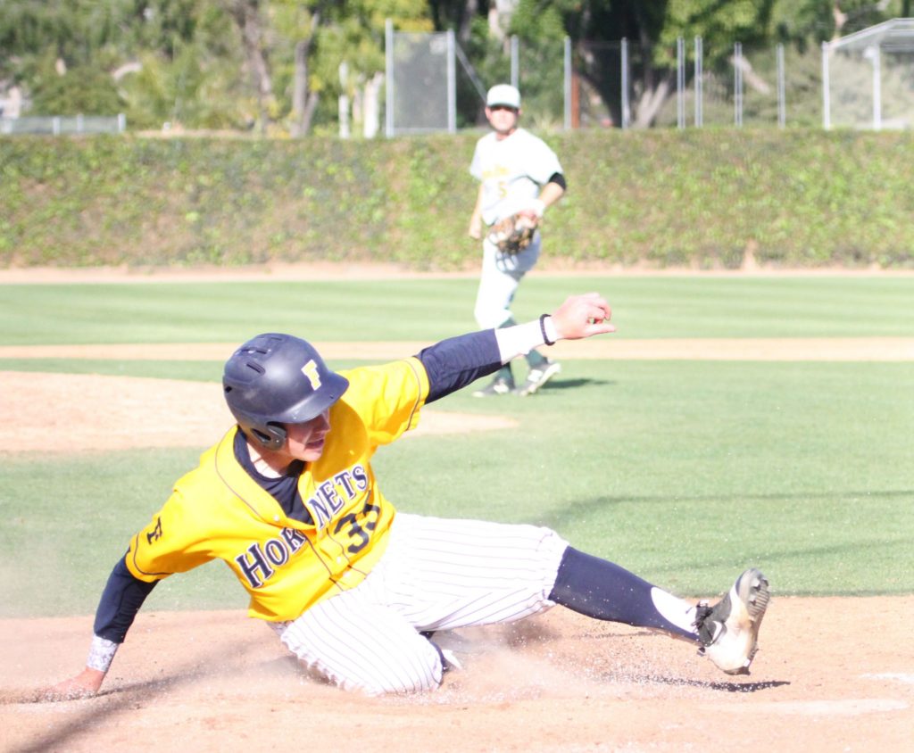 Hornets outfielder, Josh McIntrye, slides safely into home upping their score at FCs season opener against Golden West on March 6. Photo credit: Stephanie Lozano