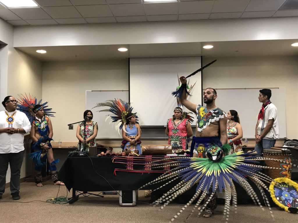 Sergio explaining to audience what the different feathers of this headdress mean. Photo credit: Valerie Sandoval