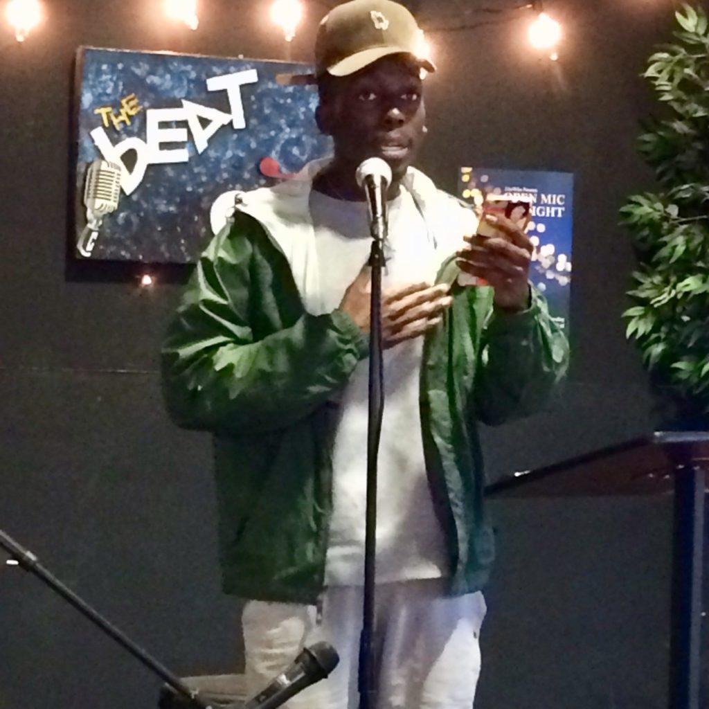Fullerton College student Rodrick Anderson reads his poetry to an attentive audience. Photo credit: Anthony Robles