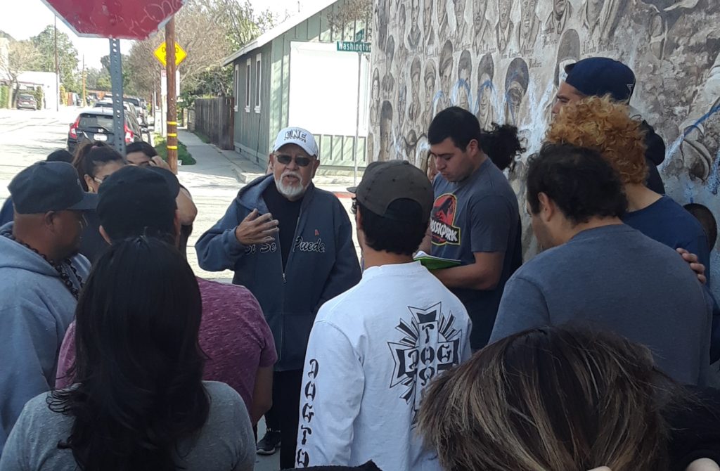 Professor Jerry Padilla addresses students and Carlos Aguilar, far left, after the artists talk. Photo credit: Tiffany Maloney-Rames