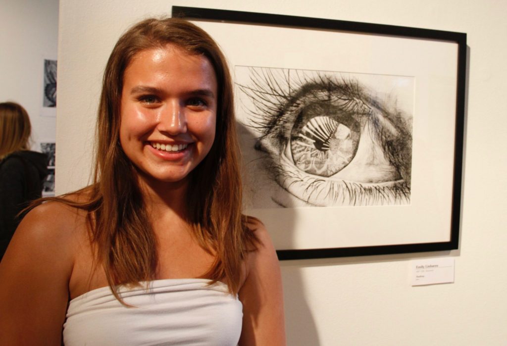 ART 120 student Emily Linhares shows her piece Audrey, which she used pen as a medium to create. Photo credit: Ayanna Banks