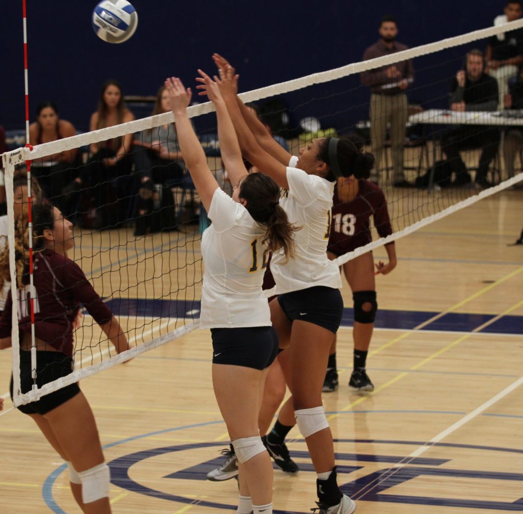 Sophomores Andrea Lopez and Samaria Longstreet go up for a block on the net against Mt. Sac Friday, August 31. Photo credit: Ciera Chavez