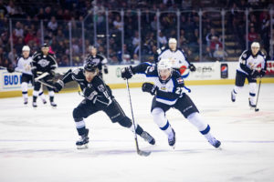 Ontario Reign forward Brandon Morrison and Colorado Eagles defender Ryan Graves both skate their way down to the net to get the possession for their team.