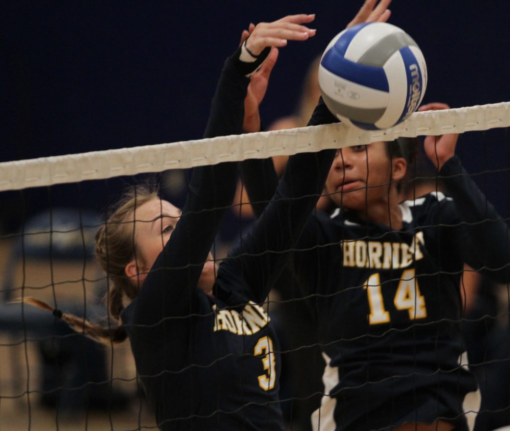 Sophomores Samaria Longstreet and Kailyn Case, go up for a successful block. Photo credit: Ciera Chavez