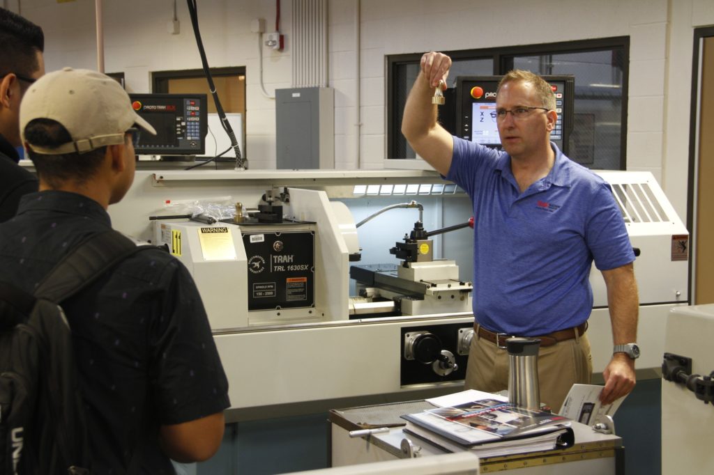 Instructor demonstrates machining to high school students on Manufacturing Day here at Fullerton College. Photo credit: Blake Ward