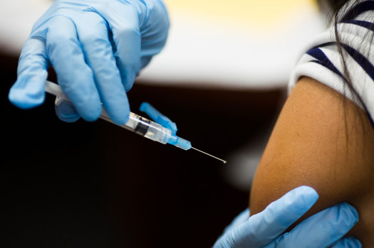 A flu shot vaccination is administered into the arm. Photo credit: CDC