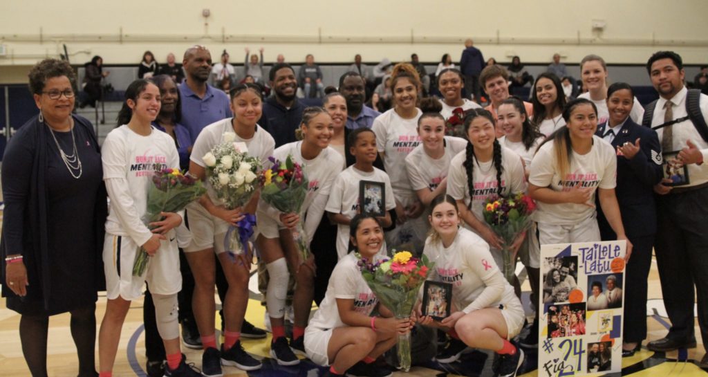 Hornets sophomore players pose with their families and coaches for their last regular season home against Copper Mountain on Wednesday, Feb. 20. Photo credit: Bovie Lavong
