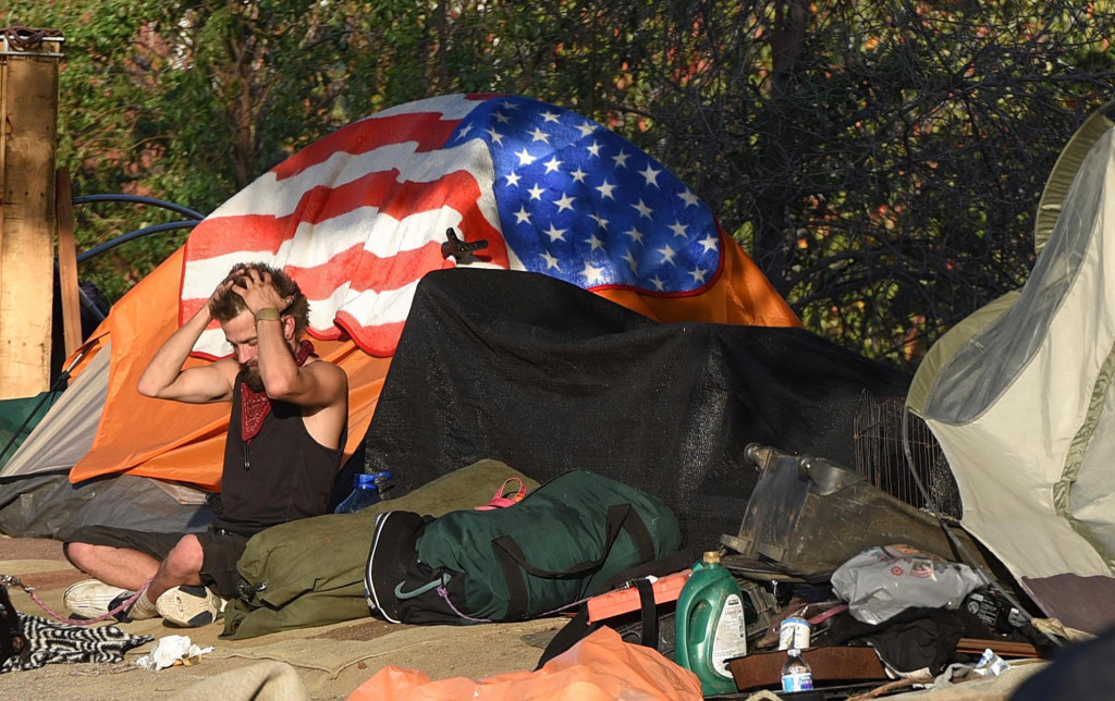 A homeless man ponders his situation outside his tent in the Honda Center homeless encampment.  The people living in the encampment are being forced off the river bed.(Photo by Bill Alkofer, Orange County Register/SCNG) Photo credit: OC Register
