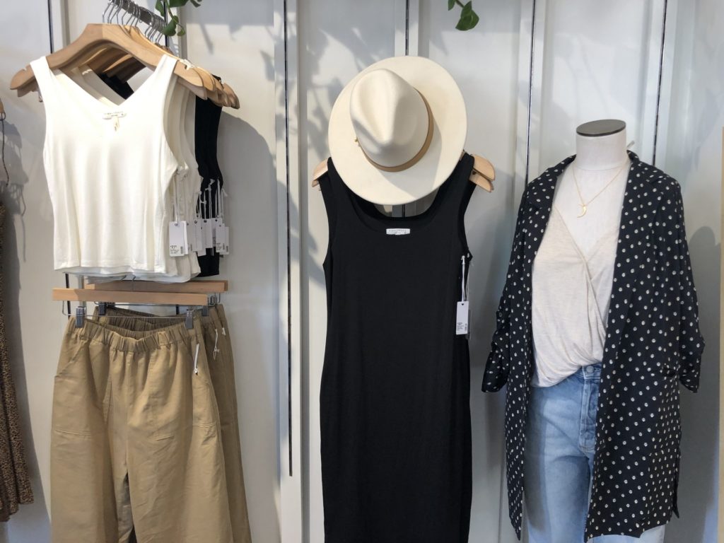 3 neutral toned outfits from Stitch & Feather. From left to right: white top ($21.50), beige pants ($42.50), white hat ($99), little black dress ($32.50), eggshell white top ($26.50), blazer ($36.50), blue jeans ($168) Photo credit: Alexis Rosa
