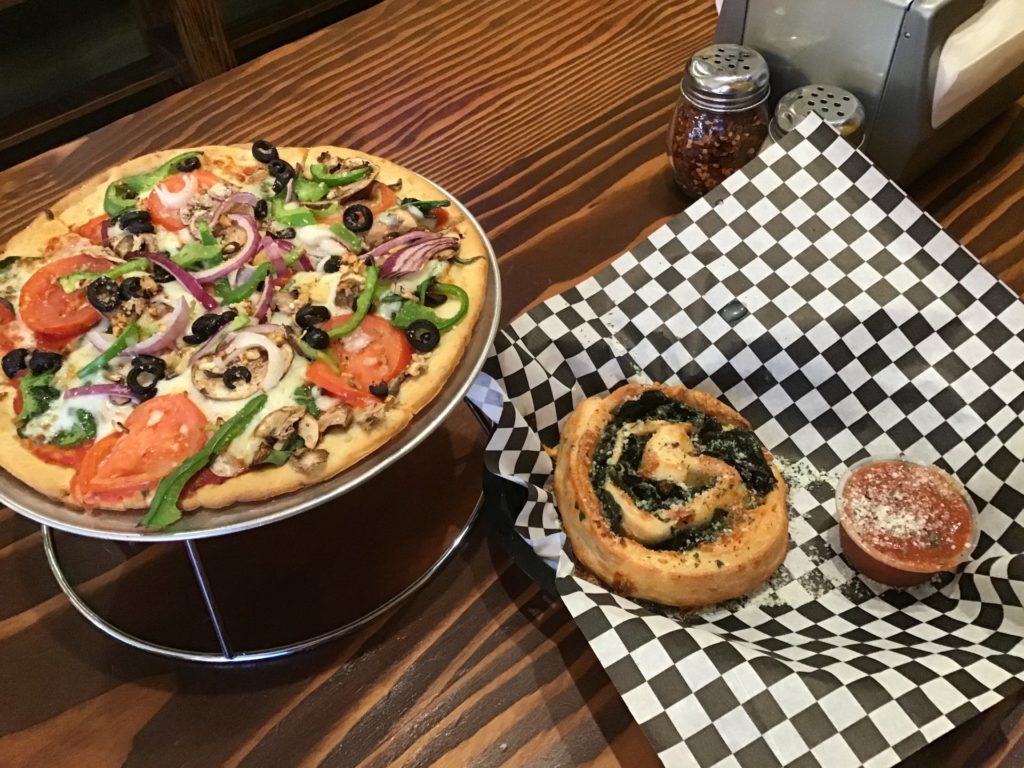 Two Saucy Broads close up photo of their Spinach Pinwheels and their Cauliflower Crust Veggie Pizza Photo credit: Roxanne Reeves