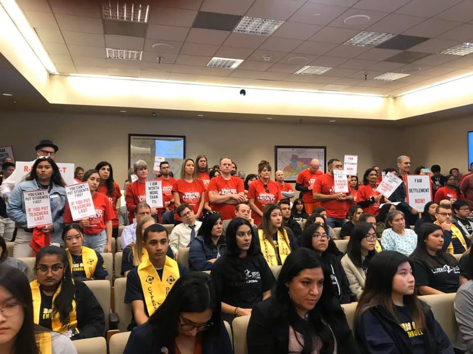Students and faculty standing and holding signs in protest at the North Orange County Community College District trustee meeting on Feb. 11, 2020. Photo credit: United Faculty North Orange County Community College District
