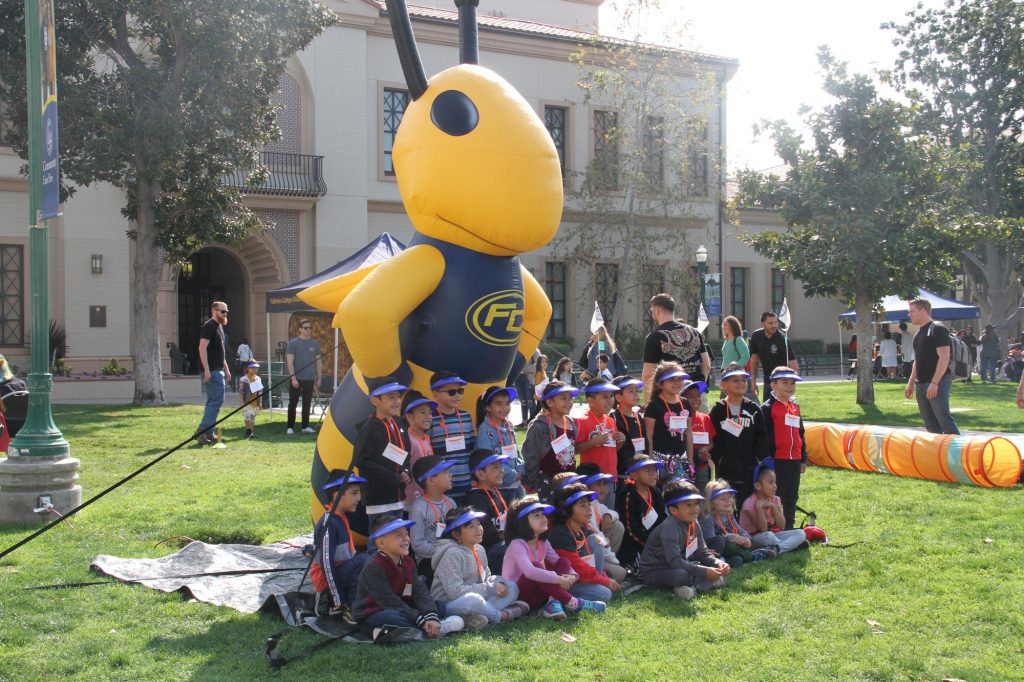 Kindergartners assemble together to take a photo with The Hornet. Photo credit: Holly Hulion