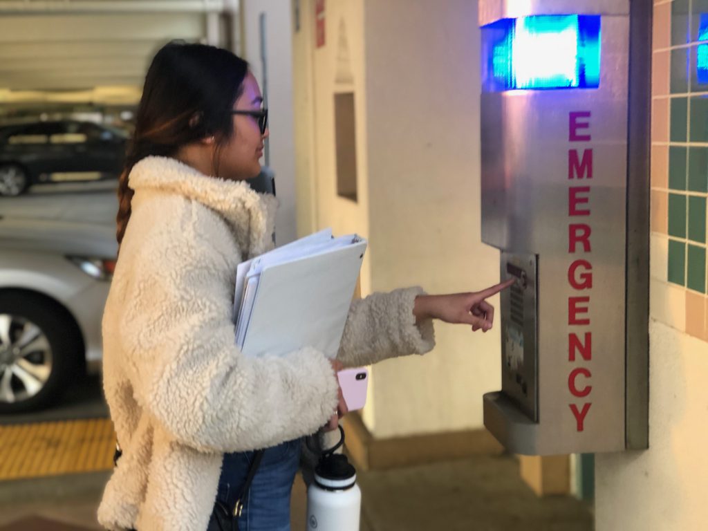 Second year Fullerton College Student, Sabella Polpantu utilizing the Campus Emergency phones located in the parking structure Photo credit: Nidia Nunez