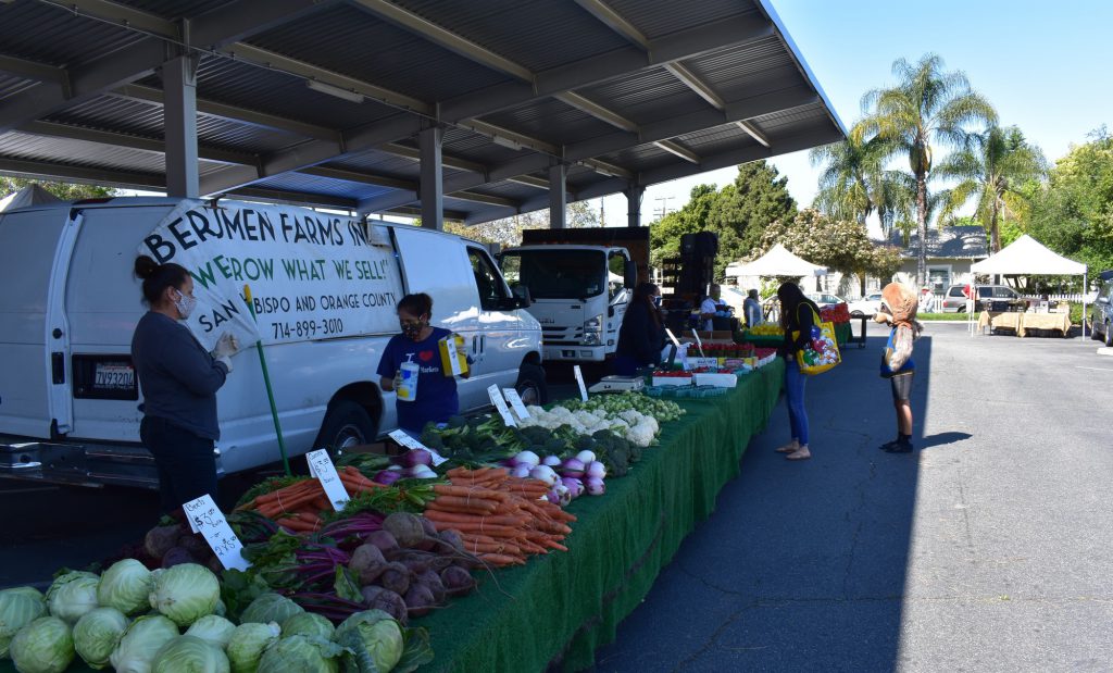 Vendors and customers following guidelines and wearing masks in public at the Fullerton Farmers Market on the Fullerton Public Librarys parking lot. Photo credit: Nidia Nunez