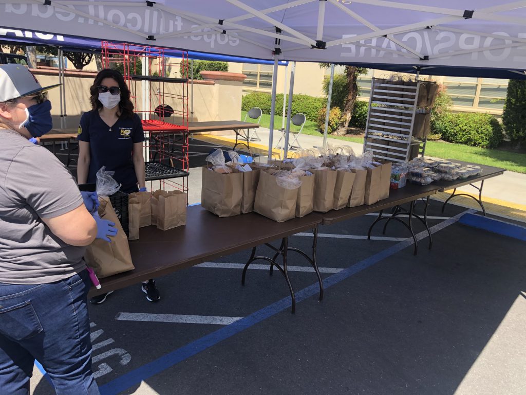 EOPS Director, Sonia Duran and staff members distributing prepackaged grocery bags to students. Photo credit: Nidia Nunez