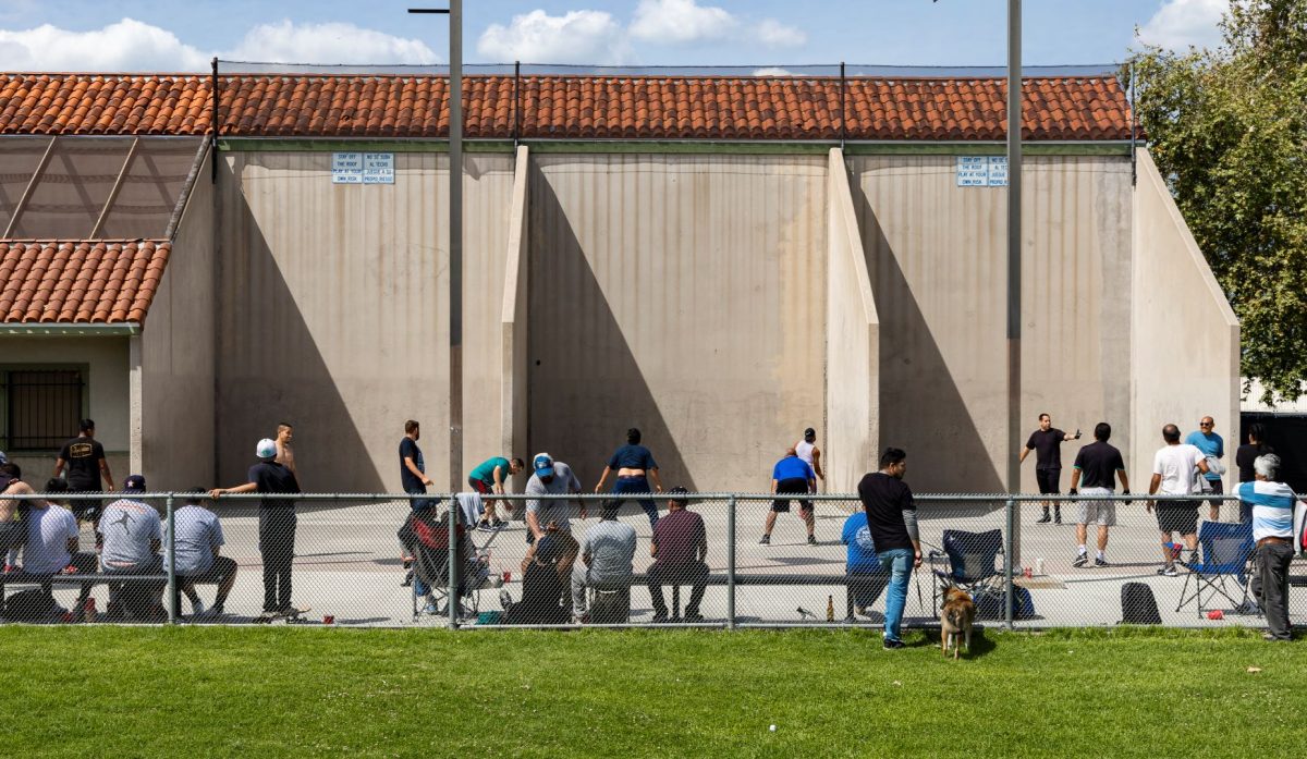  People gather at the handball courts at Independence Park in Fullerton on TKDATE. All sports courts were ordered closed on April 28. Photo Credit: Logan Martinez