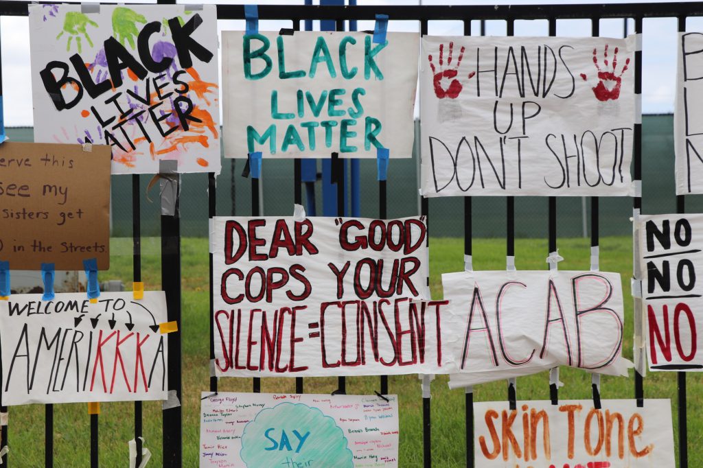 Black Lives Matter signs are posted along the gate facing Fullerton City Hall.  June 2020.