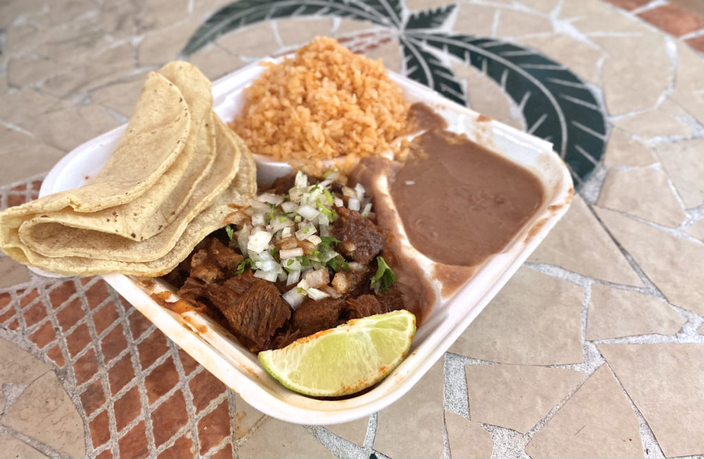 One of the many dishes that El Camino Real offers, the birria or beef stew, is served alongside rice, beans and tortillas. Photo credit: Richie Rodriguez