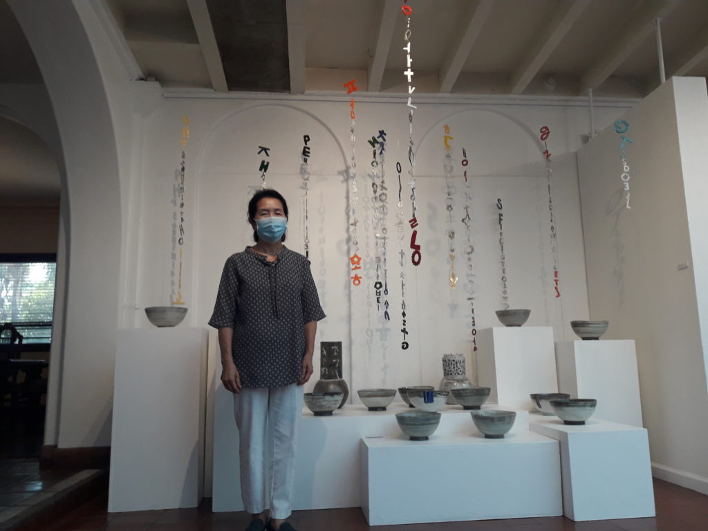Young Shin Kim stands in front of her work. Photo credit: Sudabeh Sarker