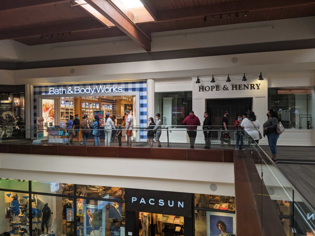 Customers wait outside Bath & Body Works while Hope & Henry has closed permanently. Photo credit: Ryan Davis